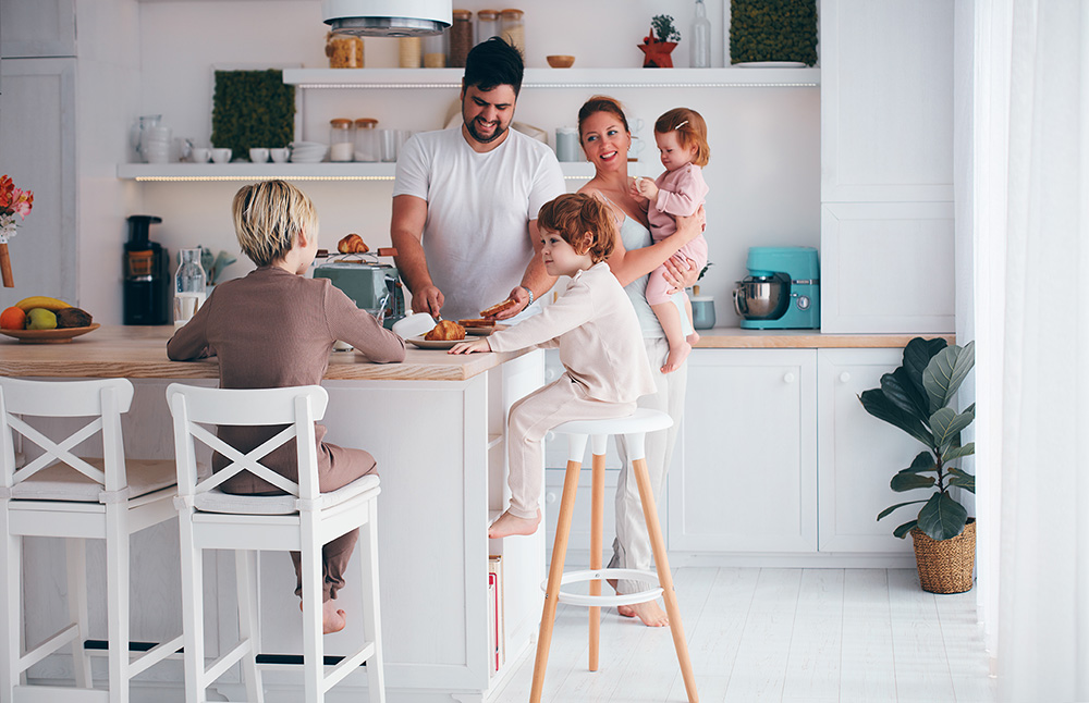 A young family gathered in the kitchen of a new modular home.